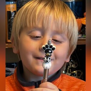 Handmade dog pawl pen made by my 4 year old grandson black & white pawl on pen